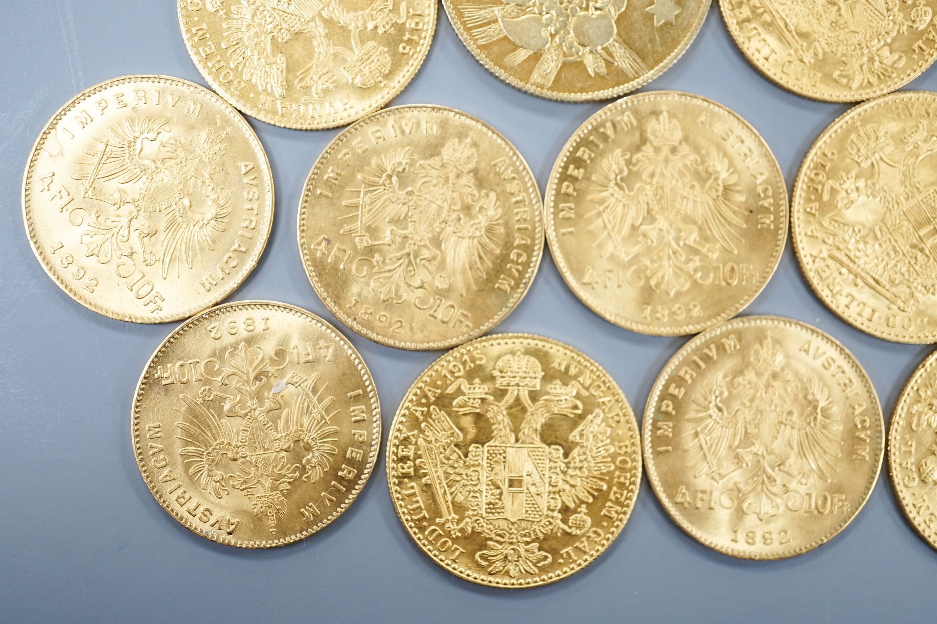 Ten Austrian gold Ducats (re-strikes) and an Italian 750 yellow metal 'I Star Lina de Amicizia'